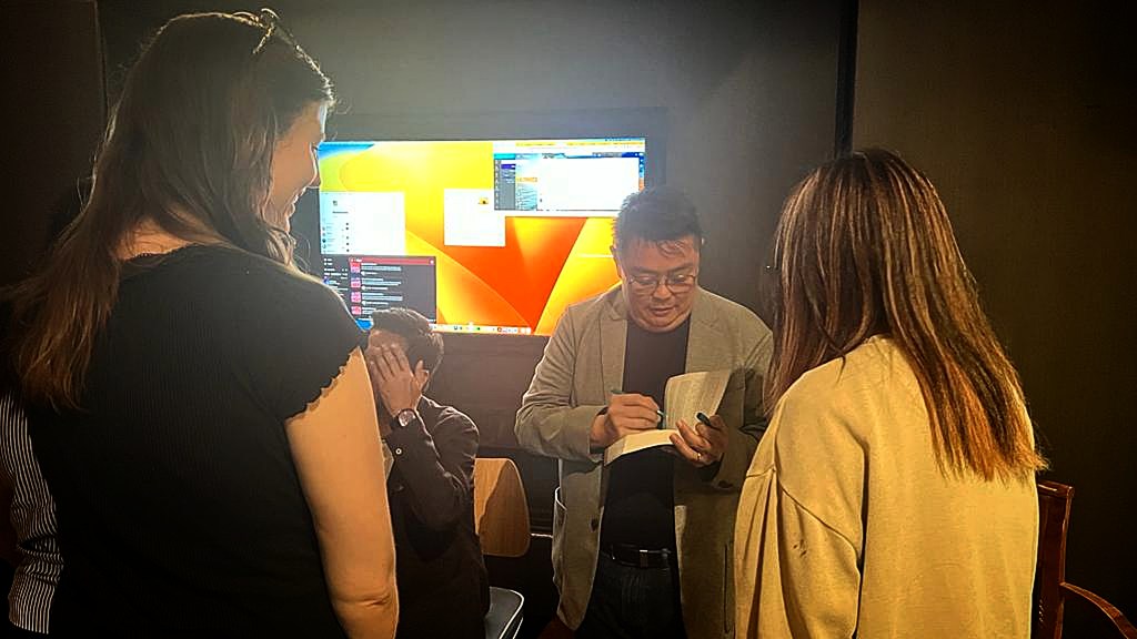 Signing autographs after the panel.